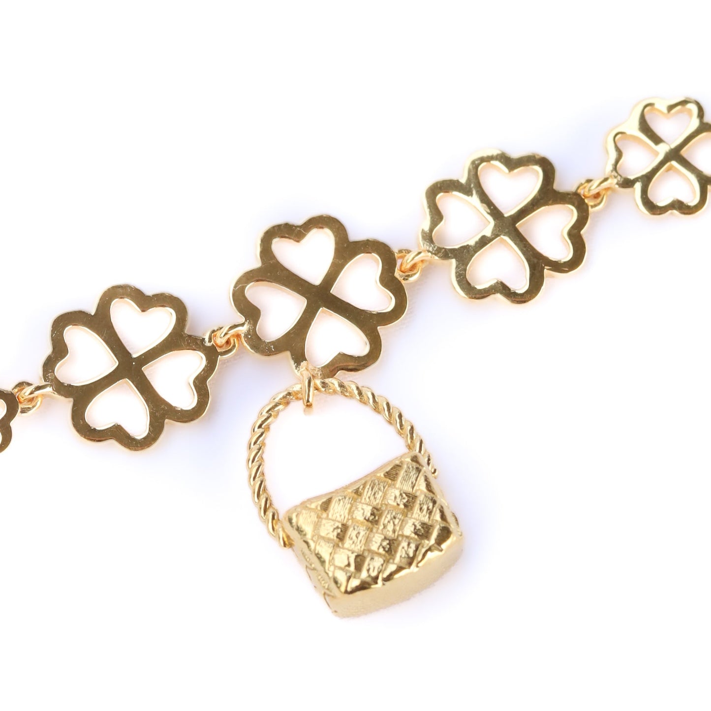 Gold bracelet with clover-shaped links on a white background