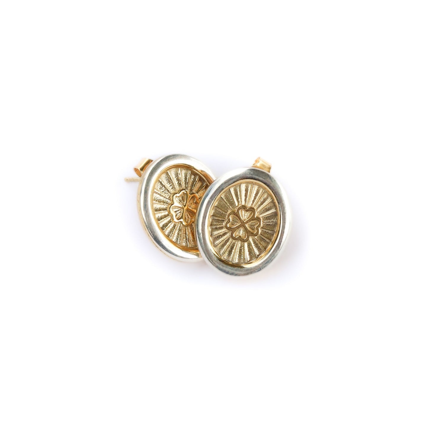 Gold circular earrings with intricate designs on a white background