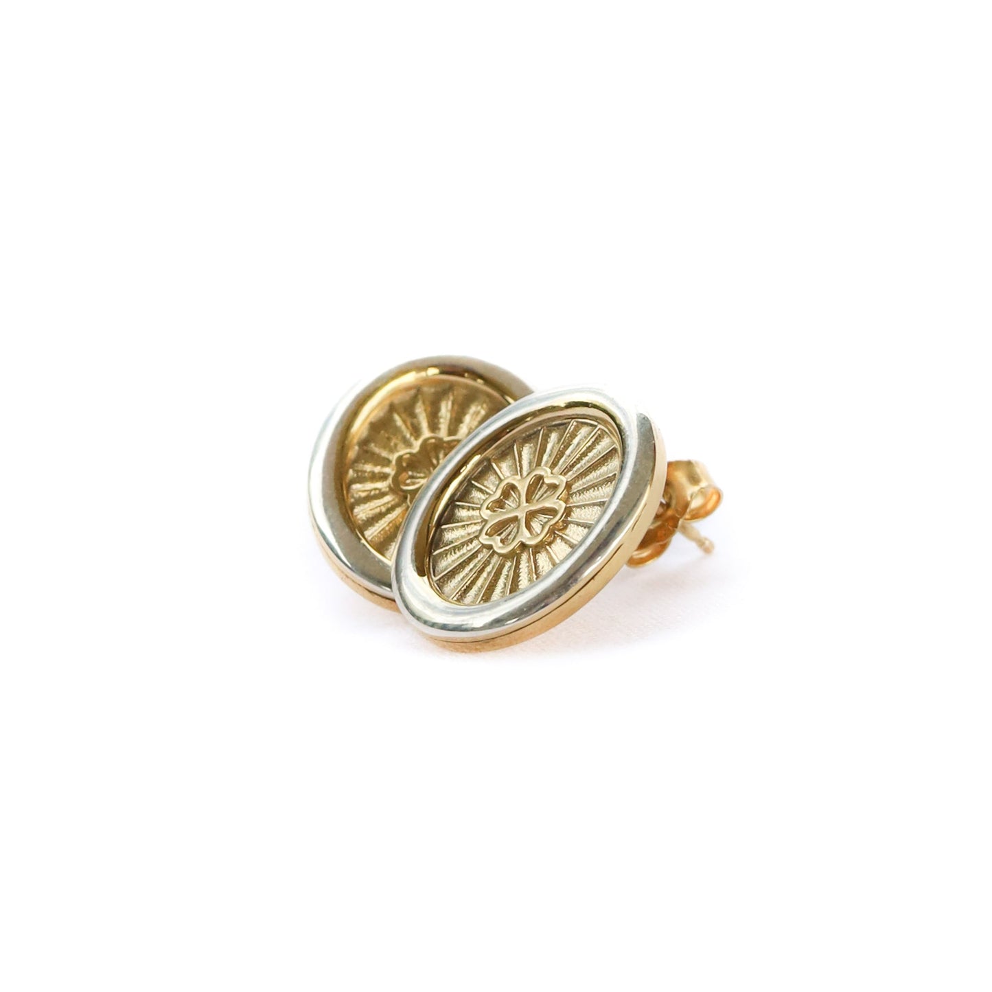Gold earrings with a sun design on a white background