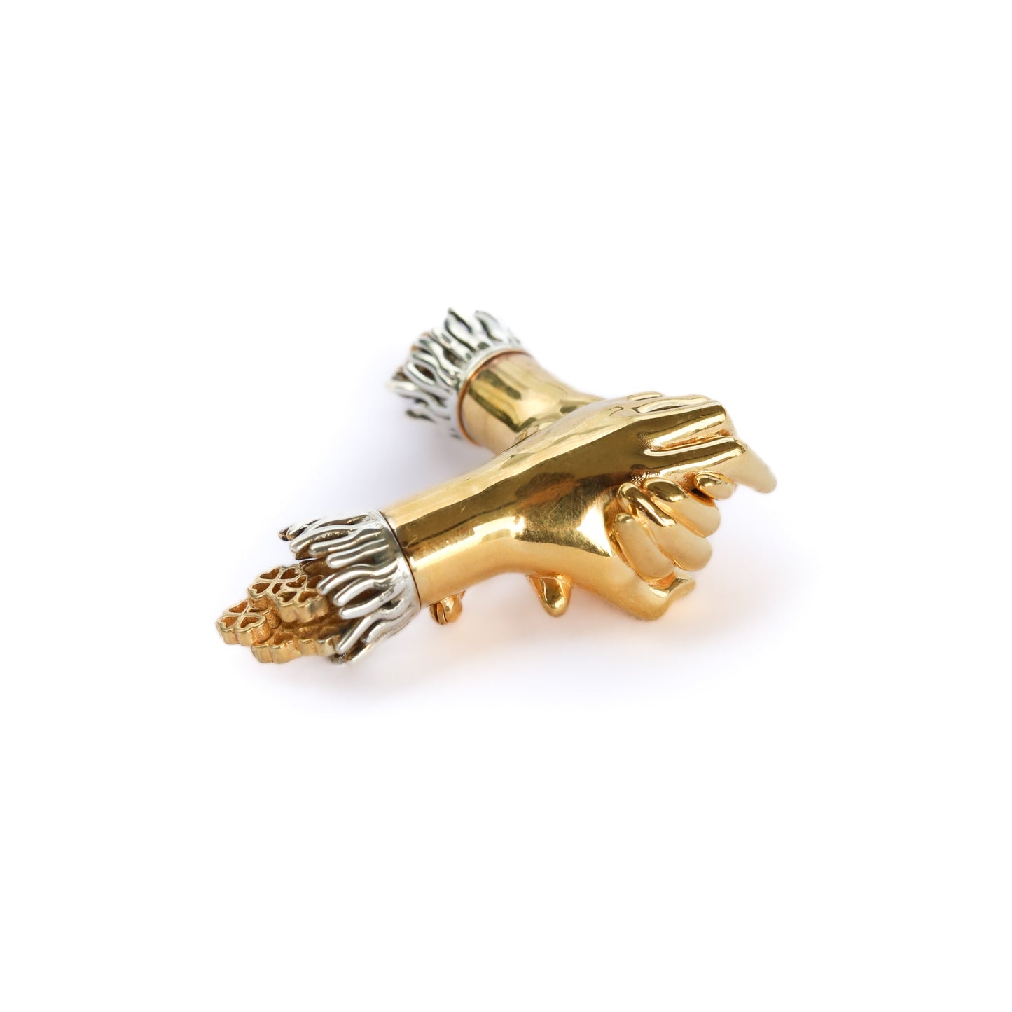 Gold and silver brooch on a white background