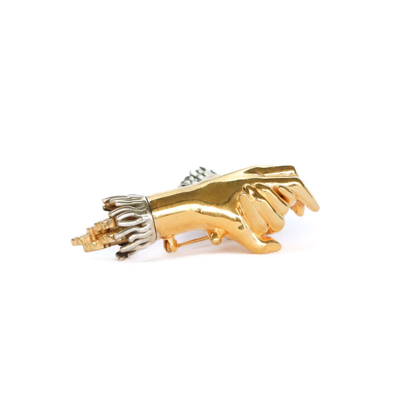 Gold and silver brooch on a white background