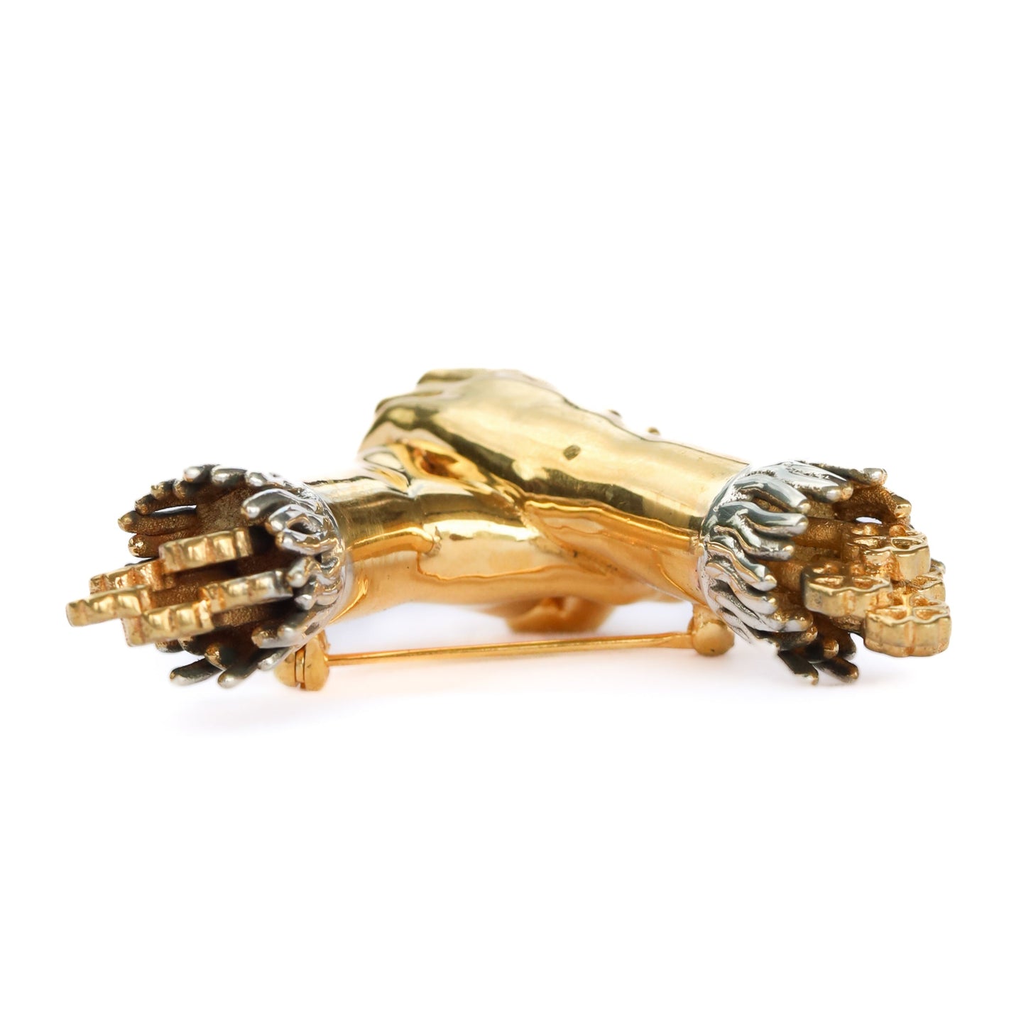 Gold and silver lion head brooch on a white background