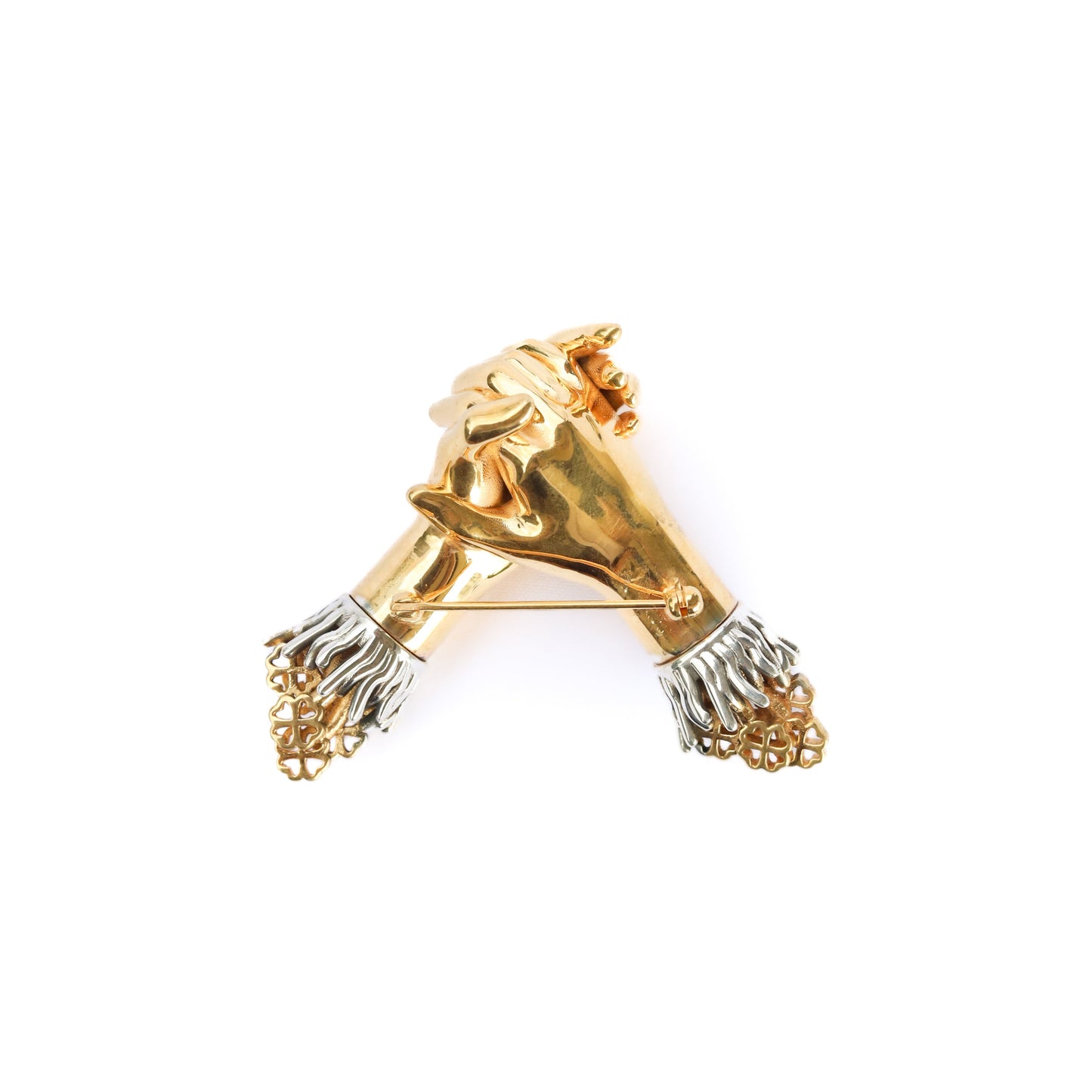 Gold and silver lion head brooch on a white background