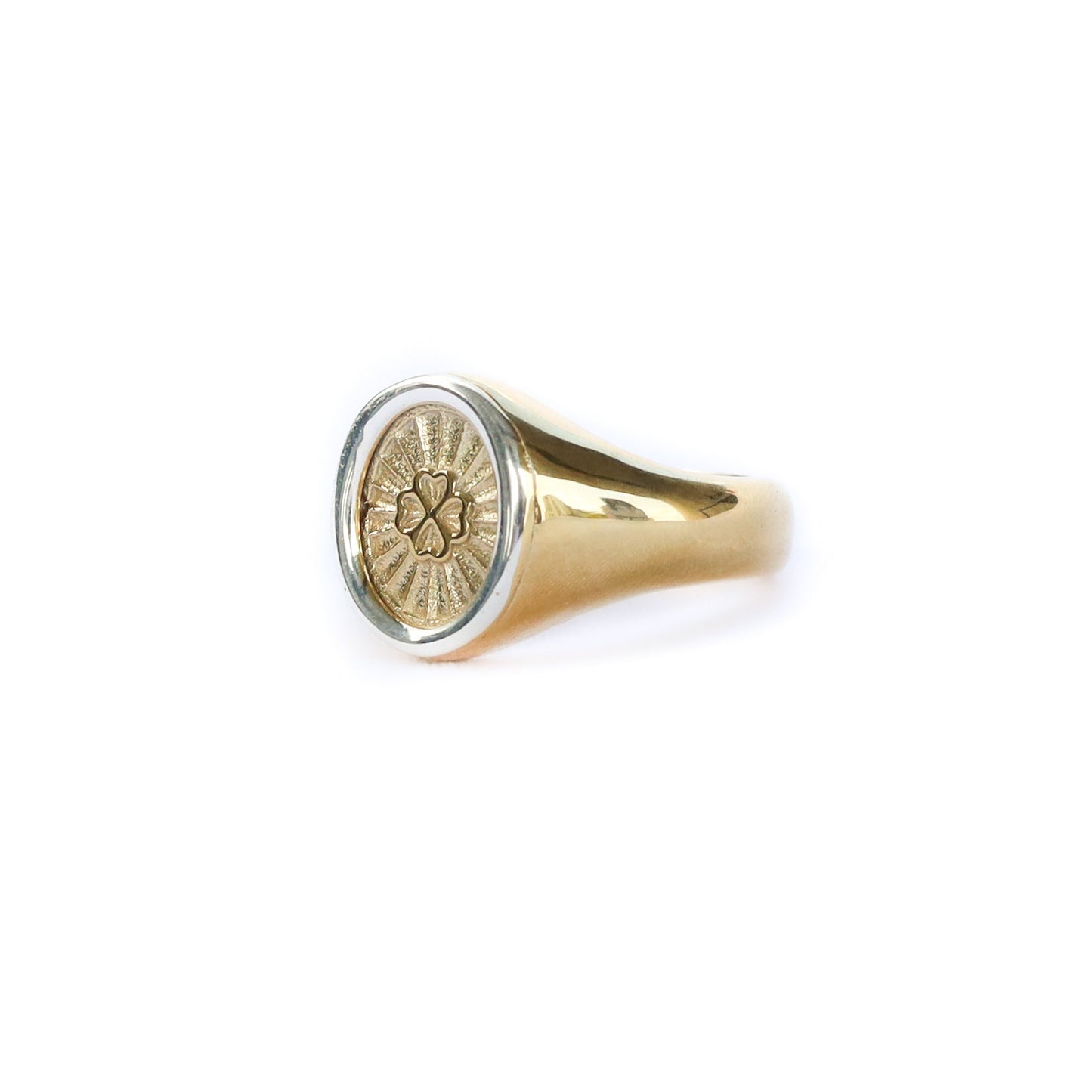Gold ring with a circular emblem on a white background