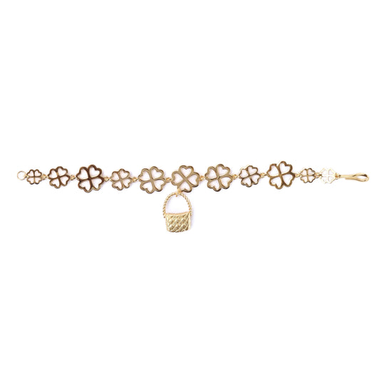 Gold bracelet with floral designs on a white background