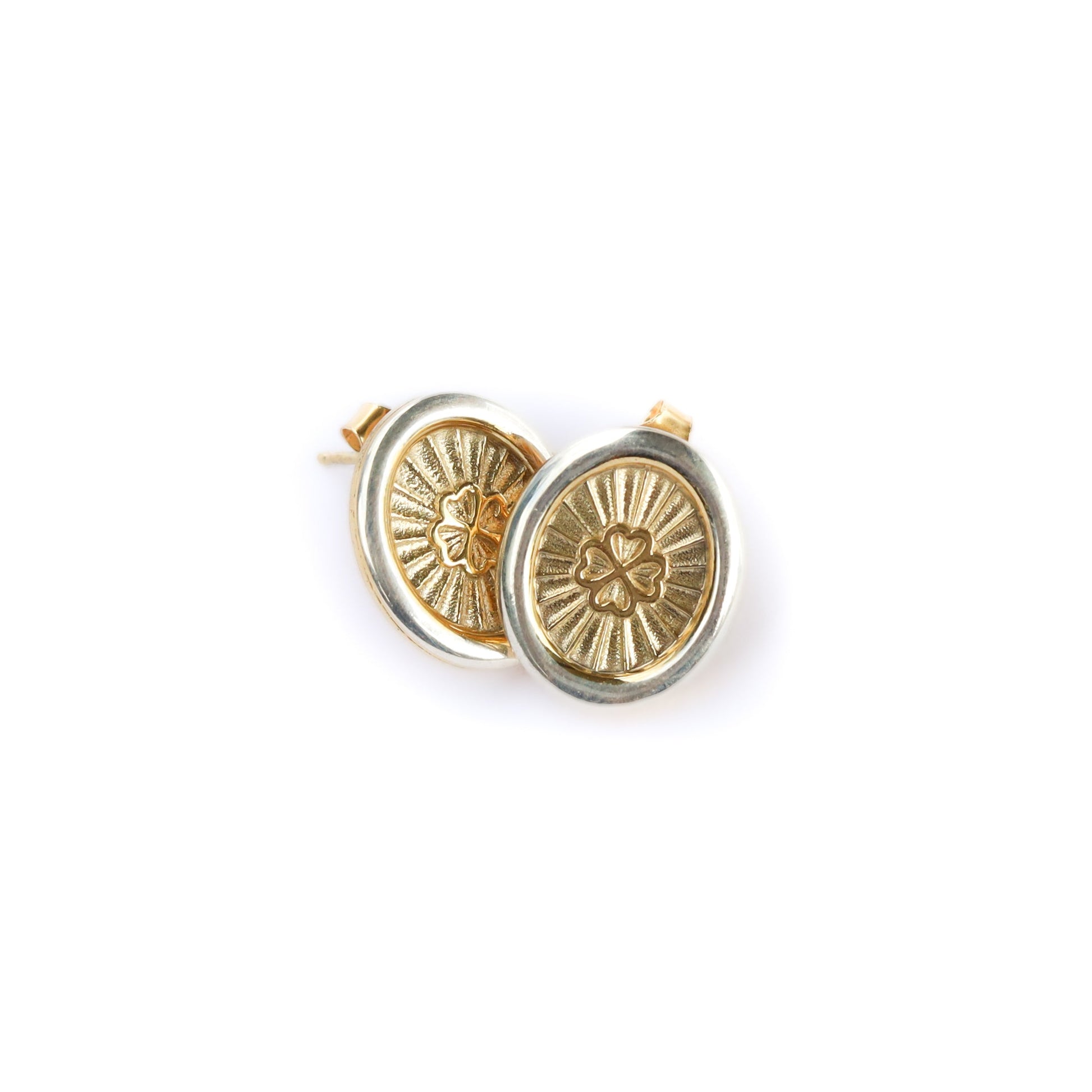 Gold circular earrings with intricate designs on a white background