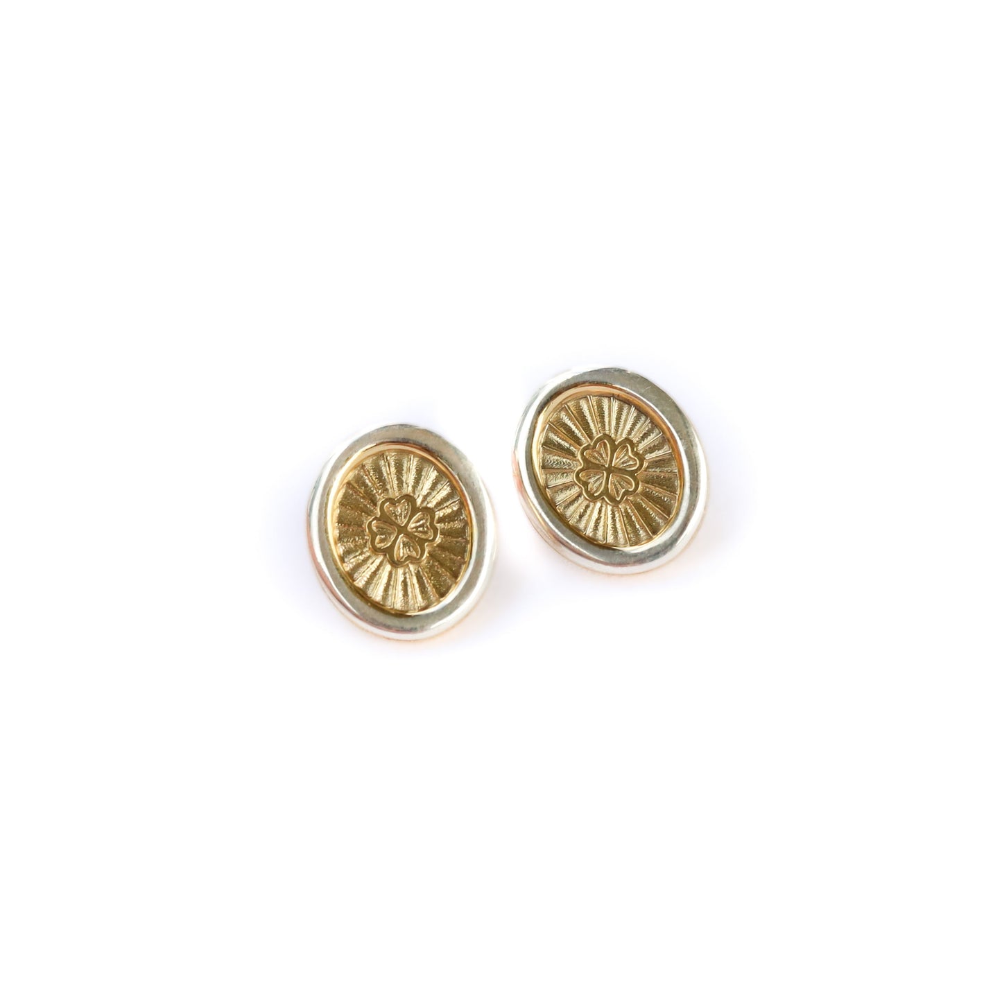 Pair of gold Jenna London earrings on a white background