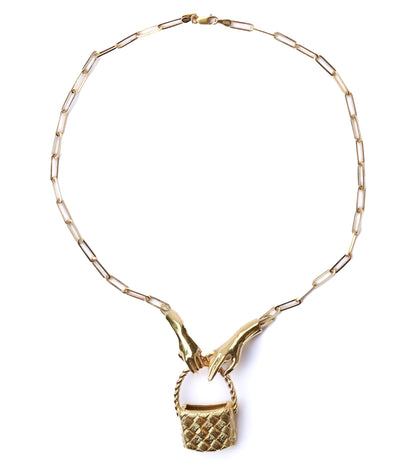Gold necklace with a basket pendant on a white background