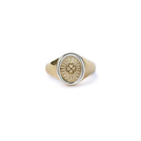 Gold ring with a circular design on a white background